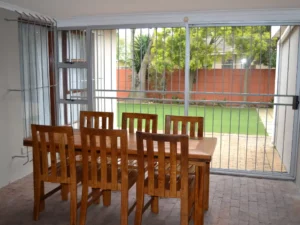 The dining area that links the living room and entertainment area at Cul-de-stay self catering accommodation, in Kuilsriver.